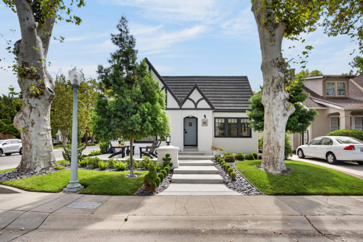 The home is framed by two mature sycamore trees.